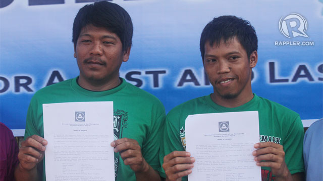FREE AT LAST. PO1 Ruel Pasion (left) and Pfc Jezreel Culango show their order of release from the custodial unit of the NPA in Laak town on Thursday, February 21. Photo by Karlos Manlupig