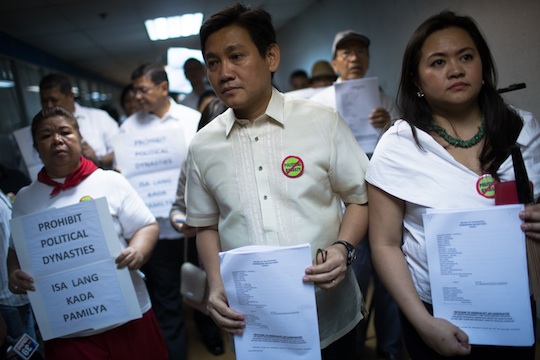  TEST CASE. Juana Change along with lawyer Alex Lacson walks with their petitions to call for the end of certain political dynasties inside the COMELEC's main office in Metro Manila. Photo by John Javellana