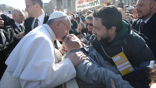 CHARISMATIC POPE. Before his homily about care for creation, Pope Francis stops to kiss a sick man during his inaugural procession. File photo from Vatican Radio's Facebook page