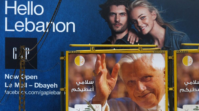 HELLO LEBANON. A poster welcoming Pope Benedict XVI appears under an billboard advertisement for a retail shop on the Dbayeh highway, north of Beirut, on September 9, 2012. AFP PHOTO / PATRICK BAZ