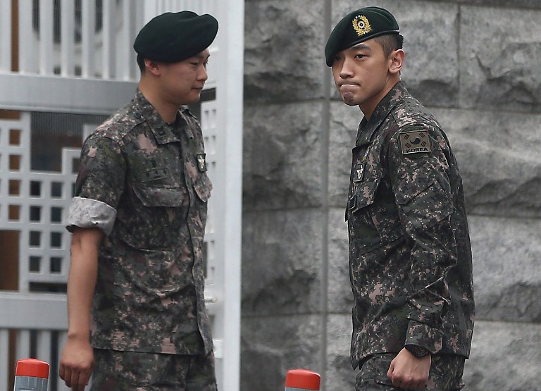 DISCHARGED. South Korean pop icon Rain (R) looks on after his discharge from mandatory military service outside the Defence Ministry in Seoul on July 10, 2013. Photo by AFP / Yonhap