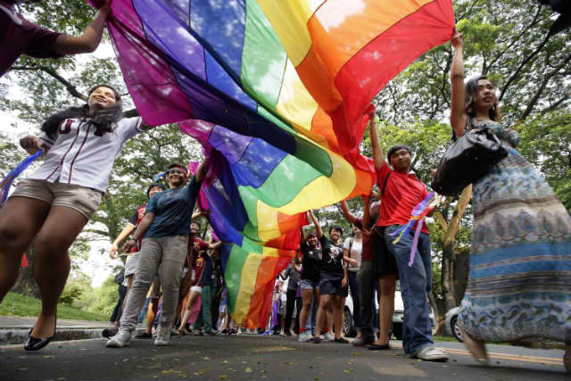 GAY PRIDE. It might take a long time before more inclusive Philippine policies are made. A good first step we can do today is to end the hate. Photo taken during the 2013 UP Pride March. Photo from Buena Bernal/Rappler.com