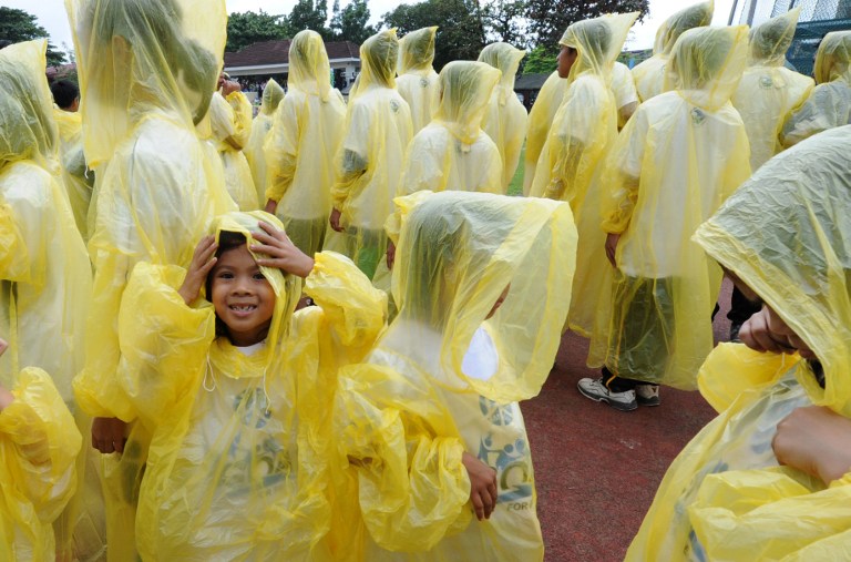 HELLO, RAIN. Filipino school children wearing raincoats during an event in Pasig city, September 2, 2012. File photo by Jay Directo/AFP