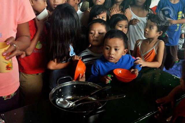 PLEA FOR AID. Children wait for their food rations in Malanday Elementary School in Marikina City. Photo by LeANNE Jazul.