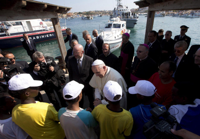 PRAYING FOR MIGRANTS. Pope Francis speaks with migrants during his visit to the island of Lampedusa, southern Italy, on July 8. Pope Francis arrives at the tiny Sicilian island of Lampedusa to pray for migrants lost at sea. Photo by EPA/Alessandra Tarantino/Pool.