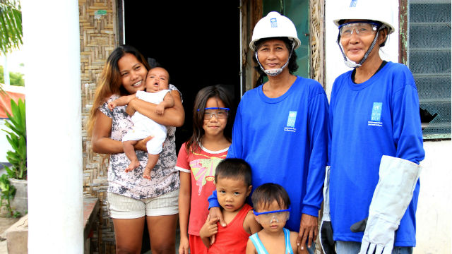 SURVIVING. Trinidad Bato-Balono smiles with her family after a clean-up operation in Santa Fe, Cebu. All photos from Anna Lamentillo