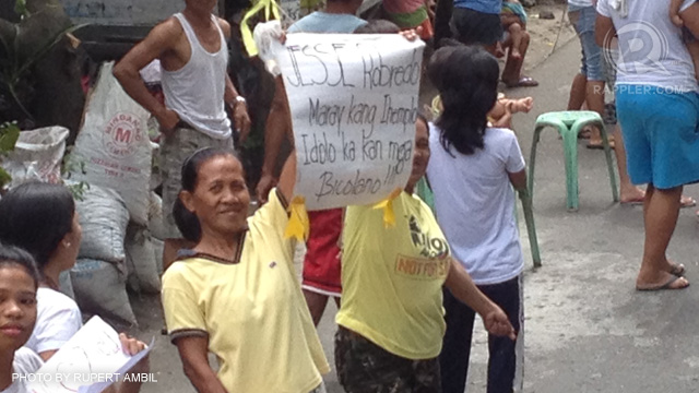 'IDOLO NIN BICOLANO.' Two women hold up a sign reading "Jesse Robredo Maray ka na ihemplo, Idolo ka kan mga Bicolano" (Jesse Robredo, A good example idol of Bicolanos) as they wait for the convoy accompanying the late Interior and Local Government Secretary Jesse Robredo at the National Highway in Pili, Camarines Sur, on the way to Naga City, August 26, 2012. Photo by Rupert Ambil.