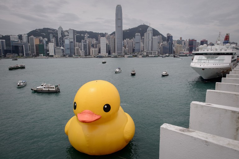 'RUBBER DUCKIE, YOU'RE THE ONE' The 16.5-meter-tall inflatable Rubber Duck art installation is seen at the Victoria Harbour in Hong Kong on May 2, 2013. The inflatable duck by Dutch artist Florentijn Hofman will be on display in the former British colony until June 9. AFP PHOTO / Philippe Lopez