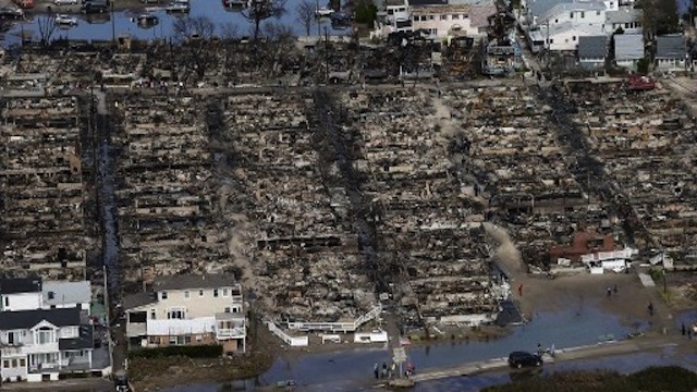 RUINS. People gather around the remains of burned homes after superstorm Sandy in the Breezy Point neighborhood of the Queens borough of New York City. Photo by Mario Tama/Getty Images/AFP