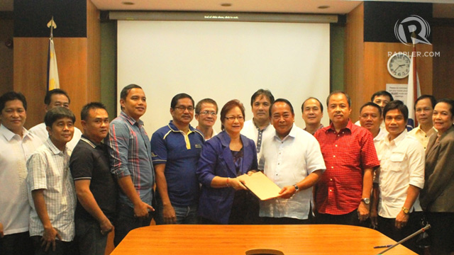 TURNOVER. San Antonio, Zambales town Mayor Estela D. Antipolo (left) hands over to SBMA Chairman Roberto V. Garcia a copy of a resolution declaring a portion of the town's southern coastal tip as an eco-tourism zone. The area is being eyed for development by the Subic Bay Metropolitan Authority (SBMA) under its expansion program. Also in photo are Vice-Mayor Lugil Ragadio and SBMA Deputy Administrator for Legal Affairs Atty. Randy B. Escolango (extreme left). Photo by Randy Datu/Rappler