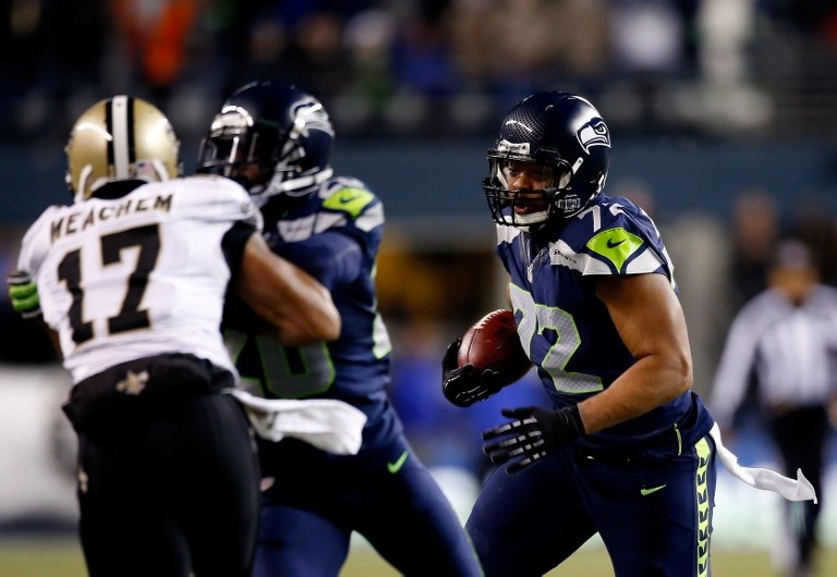 THE PLAY THAT SHOOK SEATTLE. Defensive end Michael Bennett #72 of the Seattle Seahawks runs for a touchdown after recovering a fumble against the New Orleans Saints in the first quarter during a game at CenturyLink Field on December 2, 2013 in Seattle, Washington. Otto Greule Jr/Getty Images/AFP