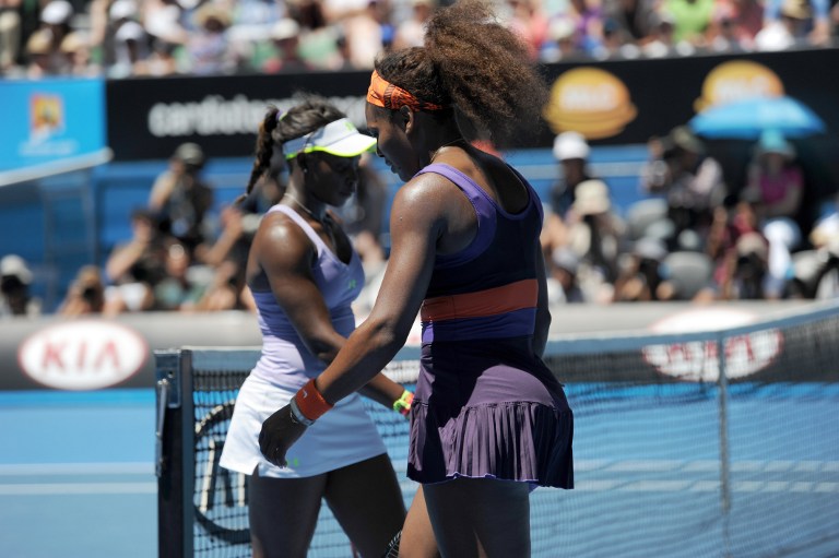 Serena Williams of the US (R) walks on court during her women's singles match against compatriot Sloane Stephens (L) on the tenth day of the Australian Open tennis tournament in Melbourne on January 23, 2013. AFP PHOTO/GREG WOOD
