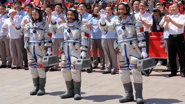 A picture made available on 12 June 2013 shows Chinese astronauts, (L-R) Wang Yaping, Zhang Xiaoguang, and Nie Haisheng, waving to people coming to see them off before their space mission in Jiuquan Satellite Launch Center in northwest, China, 11 June 2013. Photo by EPA/Liu Huaiyu