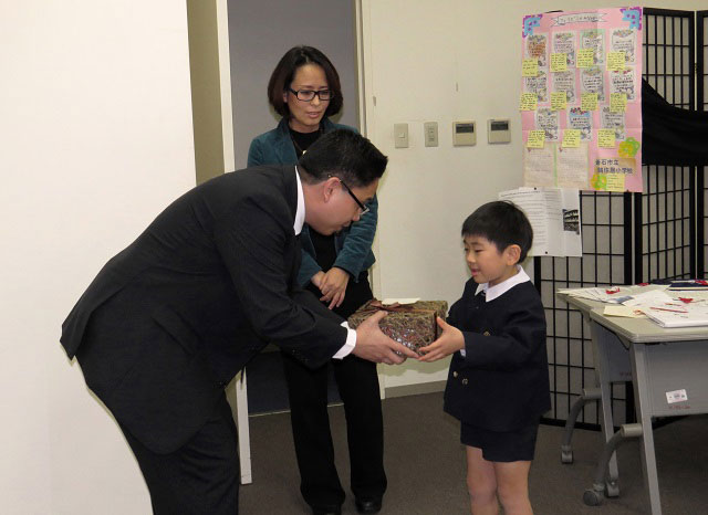 OTHER DONORS. Shoichi, 6, donates contents of his piggy bank to Haiyan victims. In return, he receives a package of jeepney toys and a T-shirt from the Philippines. File photo from the Philippine embassy in Tokyo