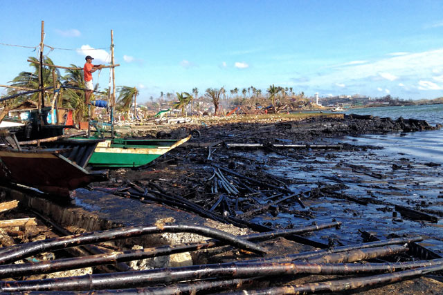 COVERED IN OIL. Logs and other pieces of wood covered along the shoreline of Barangay Botongon in Estancia town. Photo by Jonathan Jurilla, Typhoon Yolanda Story Hub Visayas