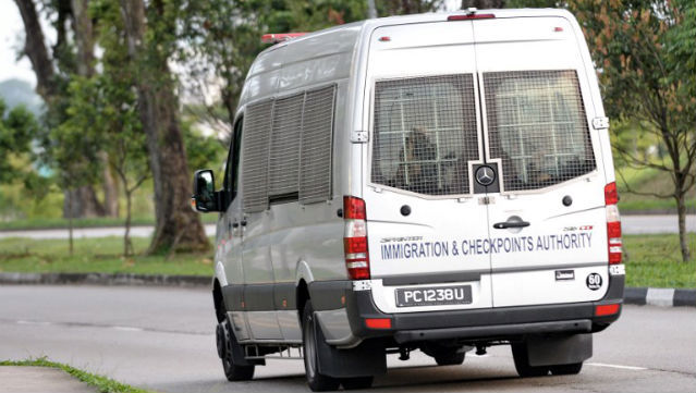 ARRESTS. This photograph taken on December 19, 2013 shows an Immigration and Customs Authority (ICA) van transporting arrested foreign workers as it leaves the Admiralty West Prison in Singapore. AFP Photo