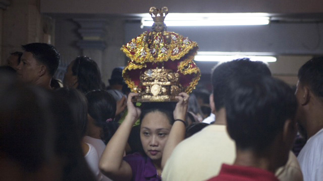 ALL SET. A lady waits inside the Basilica del Sto. Niño before the procession begins. Photo by Jon Cabiles