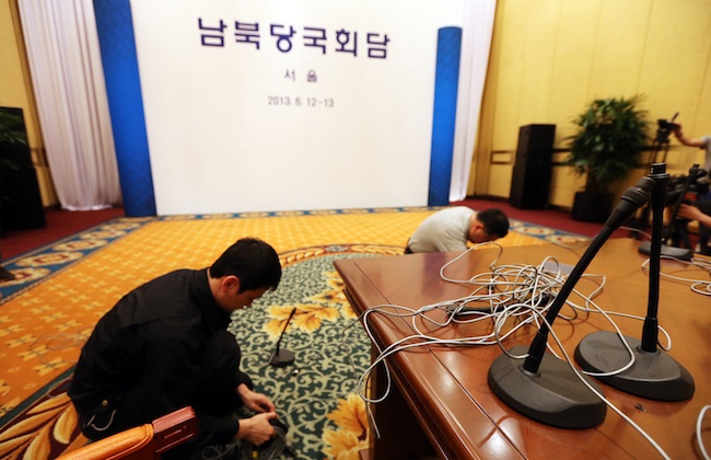 CANCELLED. Workers disconnect microphones at a conference room of a hotel in Seoul, South Korea, late 11 June 2013 after planned inter-Korean talks were called off. EPA/YONHAP