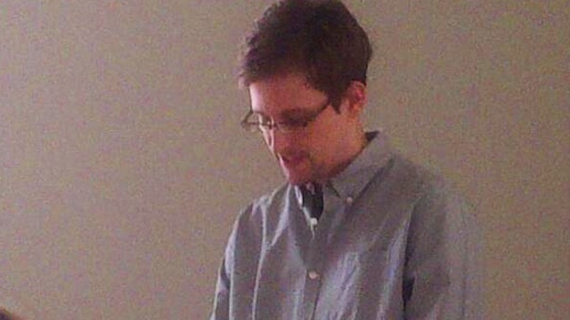 RUSSIAN CUSTODY. A newspaper report says while in Hong Kong, Snowden already called Moscow from the Russian consulate in Hong Kong. He is shown at the Sheremetyevo airport in July 2013 in this file photo from a Human Rights Watch handout 