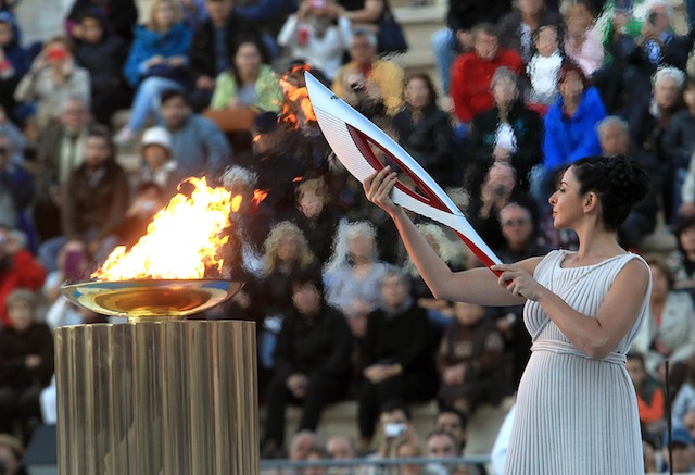 FAULTY TORCH? Actress Ino Menegaki, in the role of the High Priestess, lights the torch with the flame during the handover ceremony of the Olympic flame for the Winter Olympic Games Sochi 2014 at the Panathenaic stadium in Athens, Greece, 05 October 2013. EPA/Simela Pantzartzi
