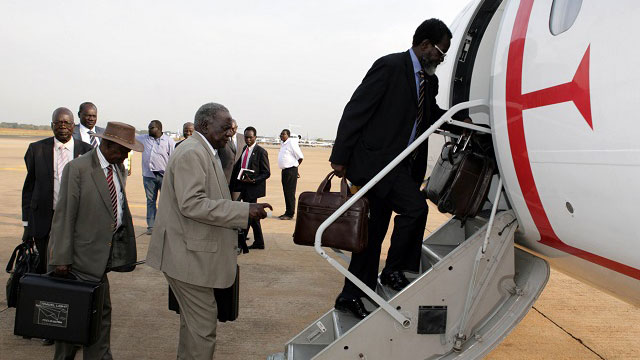 PEACE TALKS? nidentified South Sudanese government delegates board an airplane to Addis Ababa, at the airport in Juba, South Sudan, January 2, 2014. File photo by Phillip Dhil/EPA