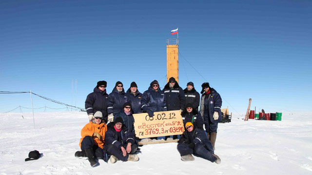 A handout photo provided by the Russia’s Arctic and Antarctic Research Institute taken at the Vostok station in Antarctica on February 5, 2012, shows Russian researchers posing for a picture after reaching the subglacial lake Vostok. The scientists hold the sign reading: "05.02.12, Vostok station, boreshaft 5gr, lake at depth 3769.3 metres." AFP PHOTO / ARCTIC AND ANTARCTIC RESEARCH INSTITUTE PRESS SERVICE
