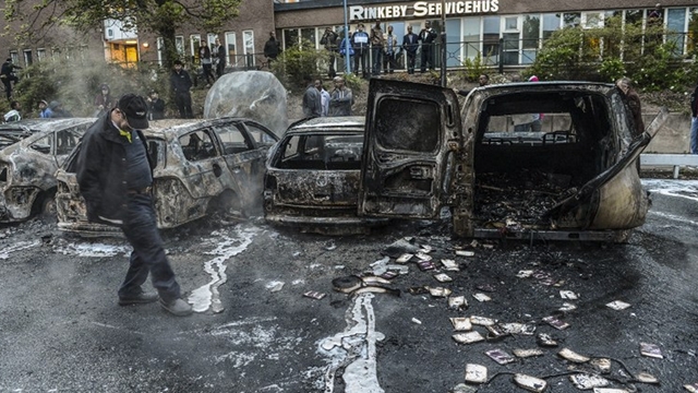 IMMIGRATION PROBLEM. A bystander checks the debris of burnt out cars in Stockholm after riots in response to the fatal police shooting of a 69-year-old machete-wielding man. The unrest has highlighted Sweden's failure to integrate swathes of its immigrant population. AFP/Scanpix Sweden/Fredrik Sandberg