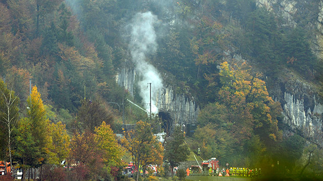 FIGHTER JET CRASHED. Smoke billows from a hillside where rescue workers tend to the scene of a plane crash in Alpnachstad, Switzerland, 23 October 2013. Photo by EPA / Urs Flueeler