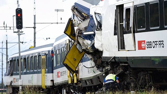 COLLISION. A rescue worker inspects the scene of a train collision in Granges-pres-Marnand in Western Switzerland. Several passengers are reported injured in the accident that caused disruption of traffics to the track section between Moudon and Payerne. Photo by EPA/Laurent Gillieron