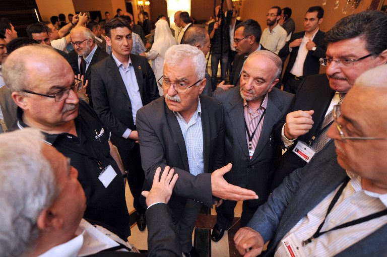 DISCUSSIONS. President of the Syrian National Council (SNC) George Sabra (C) talks with other Syrian opposition members during a break at the Syrian opposition meeting in Istanbul, on May 25, 2013. Photo by Ozan Kose/AFP