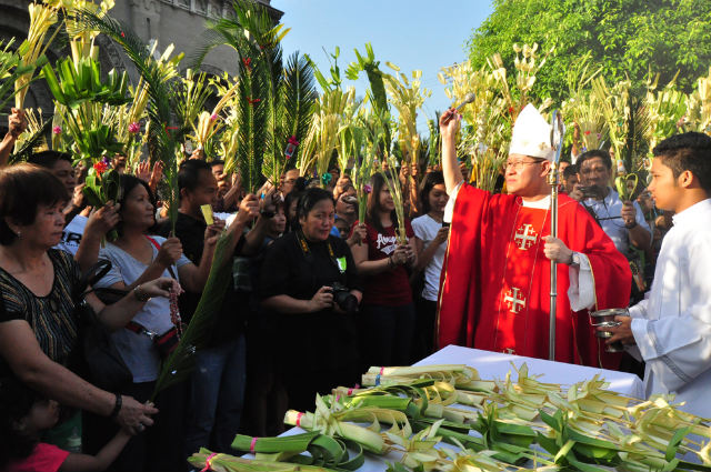 PALM SUNDAY. Manila Archbishop Luis Antonio Cardinal Tagle sprinkles holy water on palm fronds at the Manila Cathedral. Photo by Noli Yamsuan/Archdiocese of Manila