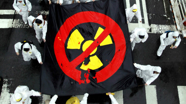 NO TO NUCLEAR. Taiwanese people carry a flag with the radioactivity trefoil symbol as they take part in a protest march during an anti-nuclear demonstration last March. Another rally was held in April, questioning the safety of nuclear plants. David Chang/EPA