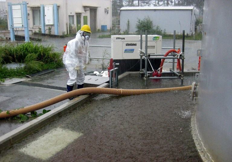 PUMPING RAINWATER. This handout picture taken by Tokyo Electric Power Co. (TEPCO) on September 15, 2013 and released on September 17 shows a TEPCO worker pumping rainwater around the contamination water tank at TEPCO's Fukushima Dai-ichi nuclear plant at Okuma town in Fukushima prefecture. AFP / TEPCO