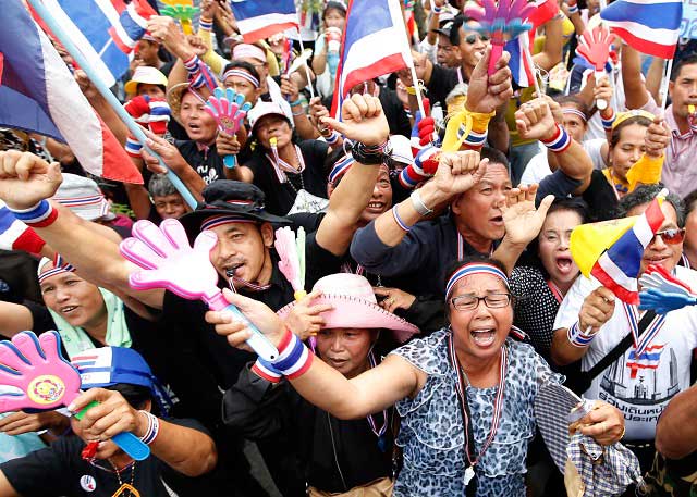 'NO OTHER DAY'. Thai anti-government protesters shout slogans during a rally occupying the Finance Ministry in Bangkok, Thailand, 26 November 2013. Photo by EPA/RUNGROJ YONGRIT