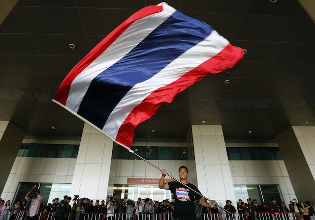 THAILAND IN CRISIS. An anti-government protester waves a Thai flag as Thais gather outside the Election Commission (EC) in Bangkok, Thailand, 17 December 2013. EPA/Narong Sangnak