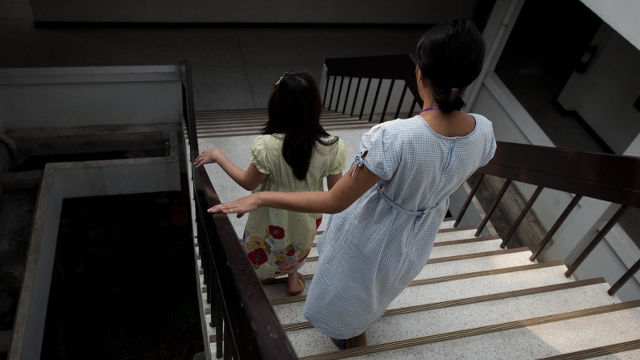 TEEN PREGNANCY. This picture taken on October 29, 2013 shows pregnant teenager Ying (R) walking down stairs with another pregnant woman (L) at the Association for the Promotion of the Status of Women (APSW) in Bangkok. Photo by Nicolas Asfouri/AFP