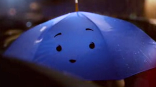 LOVE IN THE RAIN. 'The Blue Umbrella' is directed by Saschka Unseld with original score by Jon Brion. Screen grab from YouTube (WSJDigitalNetwork)