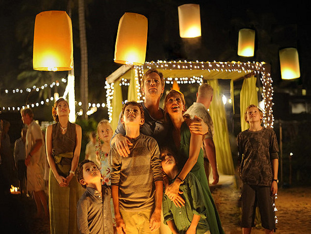 LIGHT BEFORE DARK. Oaklee Pendergast, Tom Holland, Ewan McGregor, Naomi Watts, and Samuel Joslin (foreground center, from left) at the calm before the storm