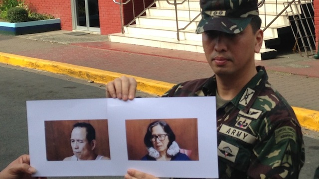 PRIZED CATCH: AFP spokesperson Lieutenant Colonel Ramon Zagala shows photos of Benito Tiamzon and Wilma Austria of the Communist Party of the Philippines