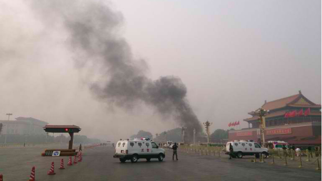 CRIME SCENE. Police cars block off the roads leading into Tiananmen Square as smoke rises into the air after a vehicle crashed in front of Tiananmen Gate in Beijing on October 28, 2013. Photo by AFP