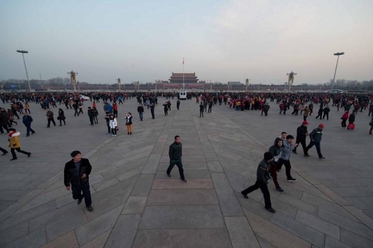 MORNING IN TIANANMEN. Tourists stand on Tiananmen Square to watch the daily flag-raising ceremony in Beijing early on March 5, 2013. Photo by Ed Jones/AFP