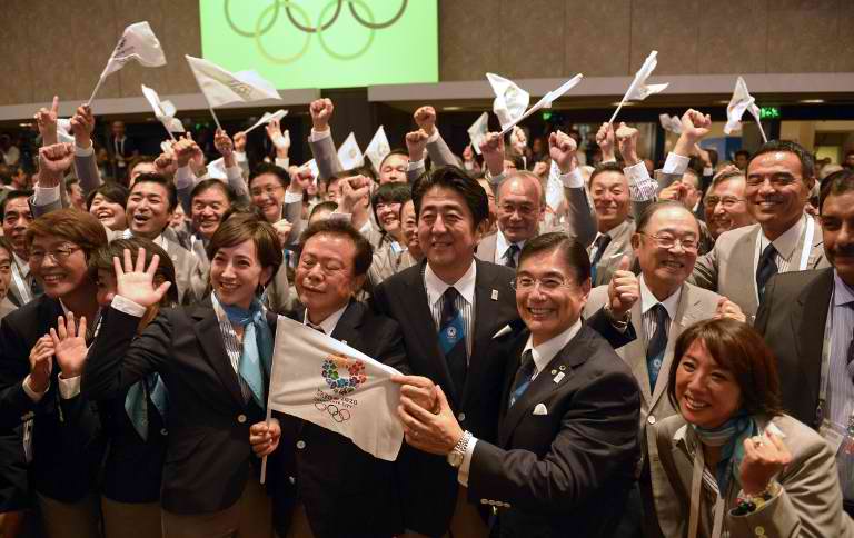 WINNING BID. Japanese Prime Minister Shinzo Abe (C) celebrates alongside Tokyo 2020 delegation members after IOC president Jacques Rogge announced the Japanese capital to be the winner of the bid to host the 2020 Summer Olympic Games, during the 125th session of the International Olympic Committee (IOC), in Buenos Aires, on September 7, 2013. AFP / Juan Mabromata