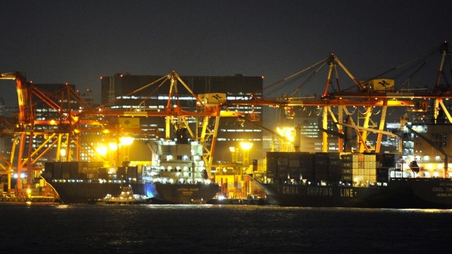 EVENING LIGHTS. This picture taken on 18 October 2013shows cargo ships berthing alongside a container wharf in the port of Tokyo. Kazuhiro Nogi/AFP