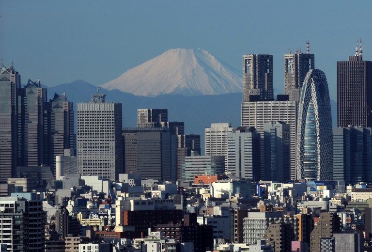 This picture taken on January 4, 2011 shows Japan's highest mountain, Mt. Fuji towering behind Tokyo. AFP / Kazuhiro Nogi