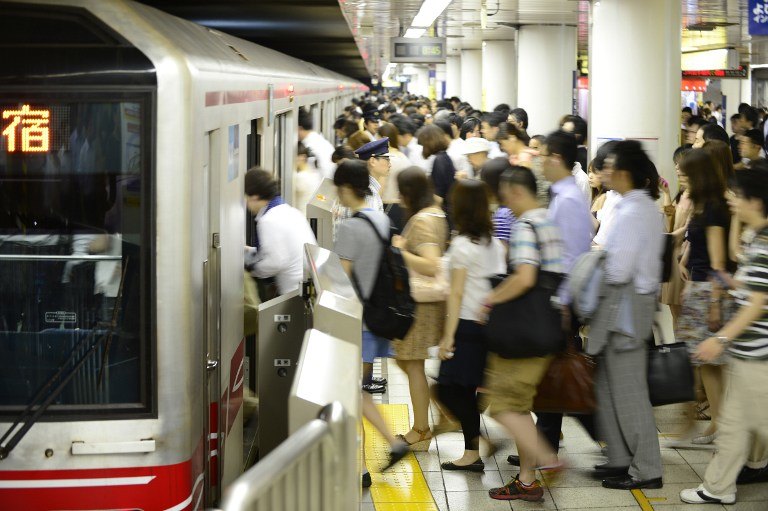 ALL ABOARD. This photo taken on July 12, 2013 shows people getting on a Marunouchi Line subway train during the morning rush hour at Ikebukuro Station in Tokyo. AFP / Toru Yamanaka