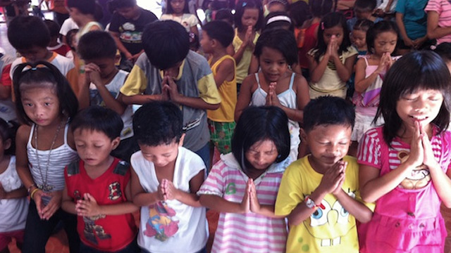 GIVE THANKS. Matangtubig children praying. All photos by Tanya Lim