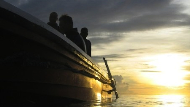 BEAUTIFUL SUNSET. Exhausted divers enjoy the view while returning to the boat to have dinner before a night dive