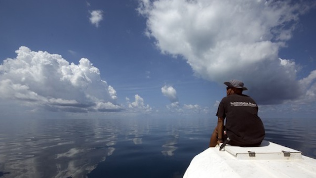 PATROLLING THE REEF. A park ranger looks out for possible intruding vessels on a patrol boat. Photo from TRNP website