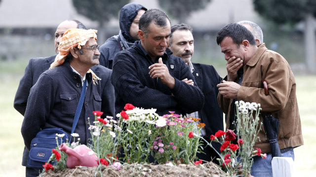 MOURNING. Relatives of the miners who were killed in a coal mine explosion mourn next to a grave at the cemetery in Soma, Manisa province, Turkey, 17 May 2014. Demonstrators hold the government of Prime Minister Recep Tayyip Erdogan responsible for the country's worst ever industrial disaster. Tolga Bozoglu/EPA
