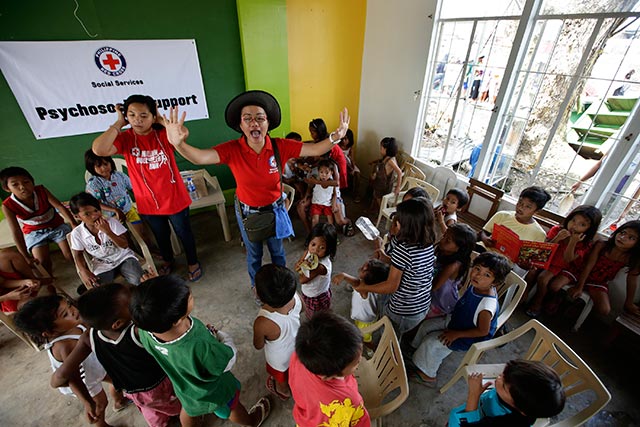 PLAY. Red Cross volunteers conduct psychosocial support for children inside a public school building turned into a temporary evacuation center in Tacloban, Leyte. Photo by EPA/Dennis Sabangan